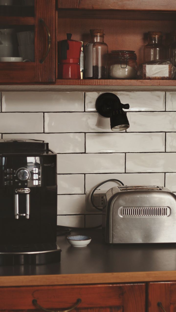 small dedicated coffee bar nook on a white kitchen counter with ceramic mugs and a drip machine