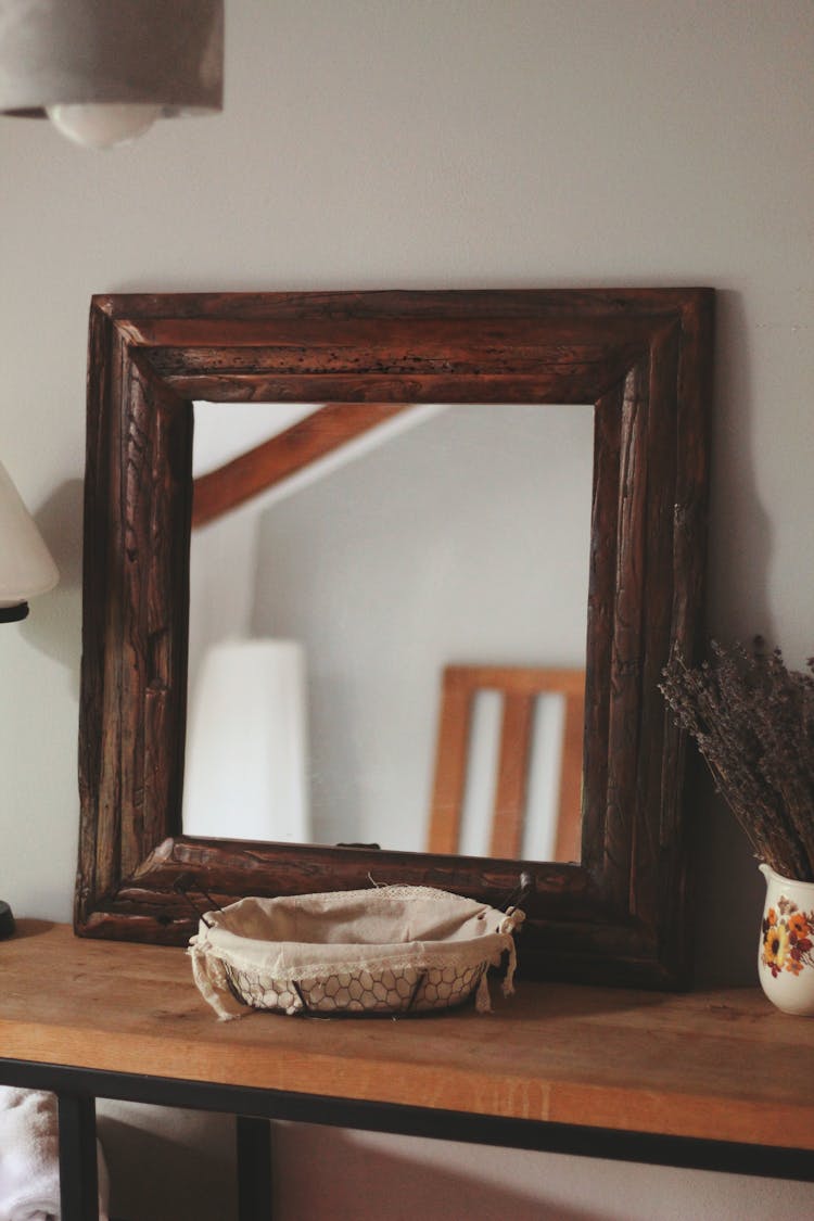 Framed Mirror On Wooden Table