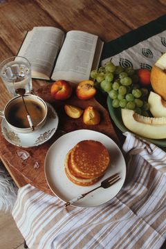 Breakfast table with pancakes and fruit, photo by Ioana Motoc on Pexels