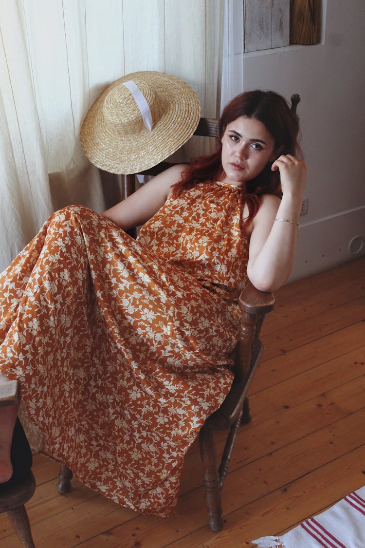 Woman Sitting On A Wooden Chair Posing