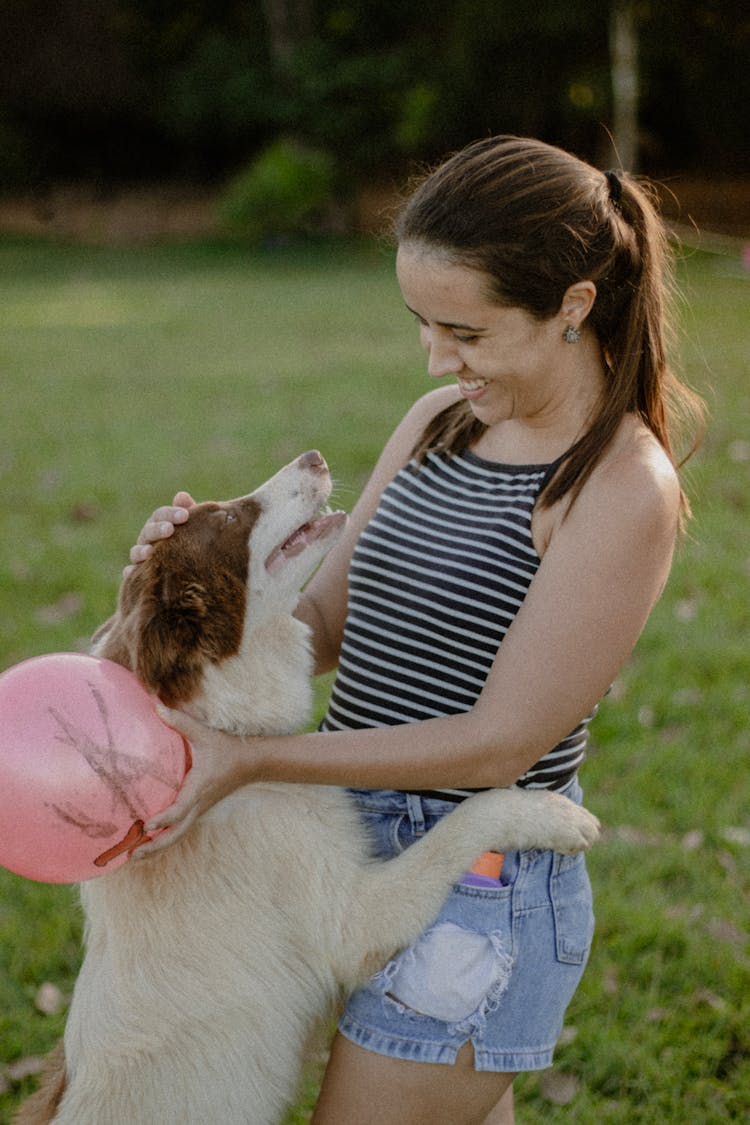 A Woman Playing With Her Dog