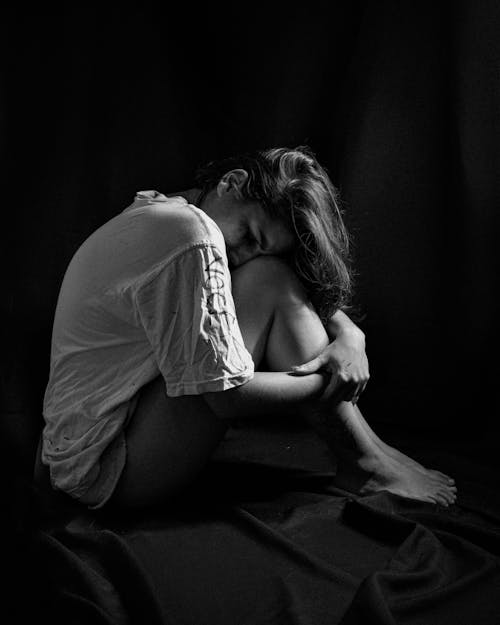 Grayscale Photo of a Lonely Woman in White Shirt
