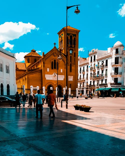 Free Bustling urban scene with historic architecture, people, and bright skies. Stock Photo