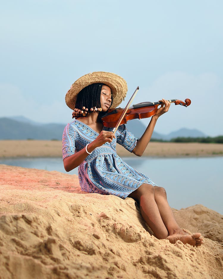 Girl Playing Violin On Sand Beach