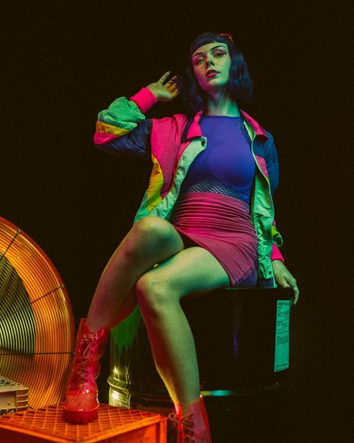 Free Stylish woman in vibrant outfit with neon lighting, exuding modern fashion vibes. Stock Photo