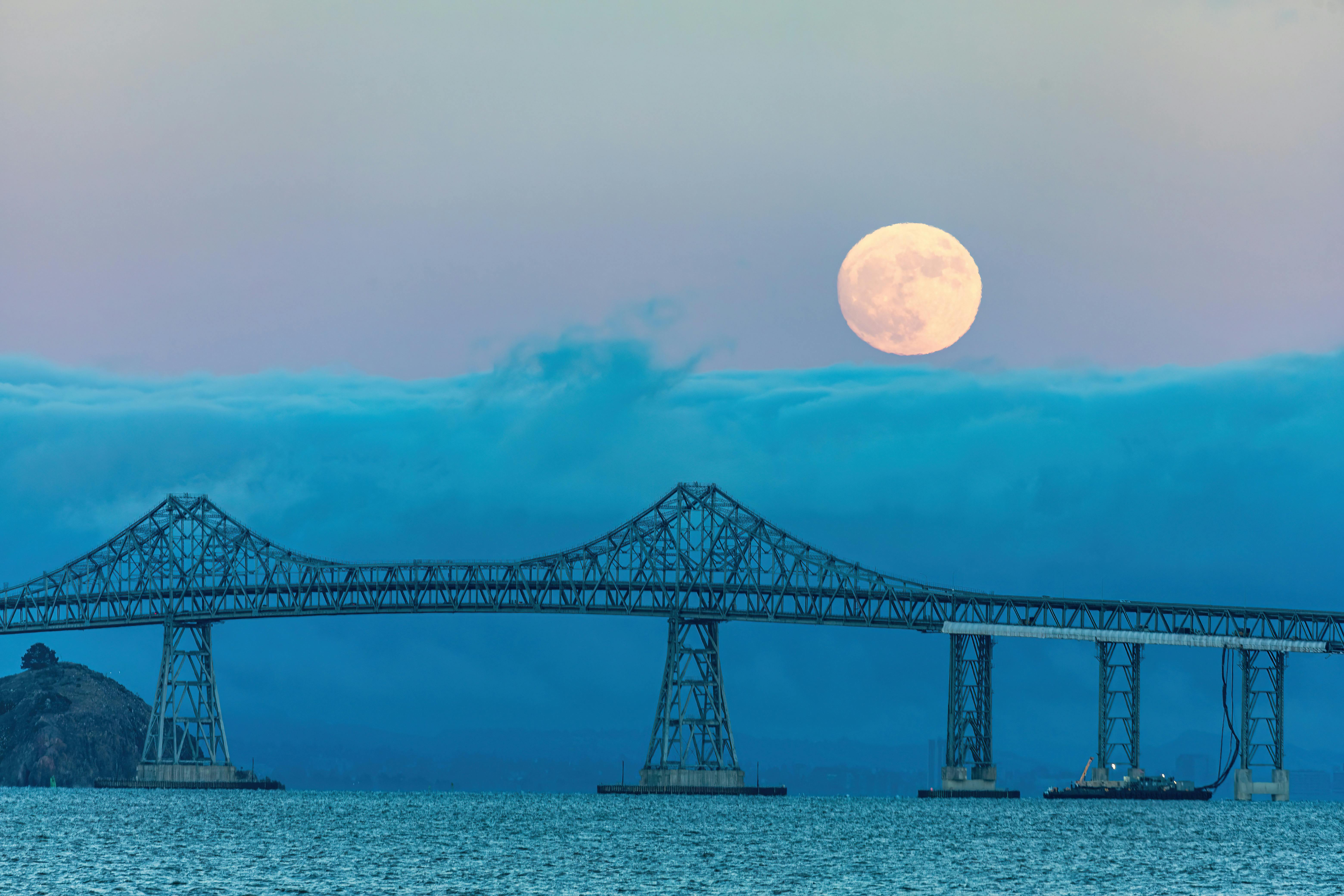 full moon and thick cloud cover over san francisco bay