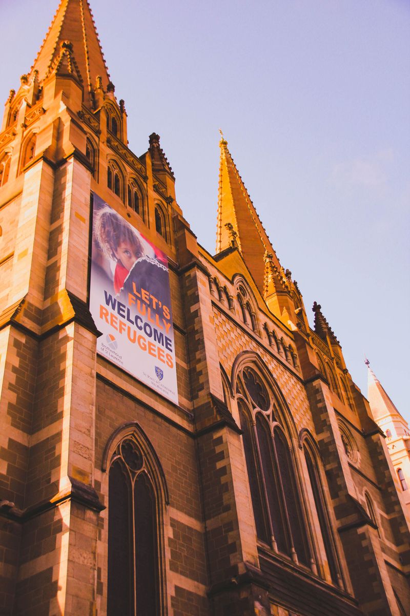 St. Paul's Cathedral in Melbourne features a welcome refugees banner on its gothic revival facade.
