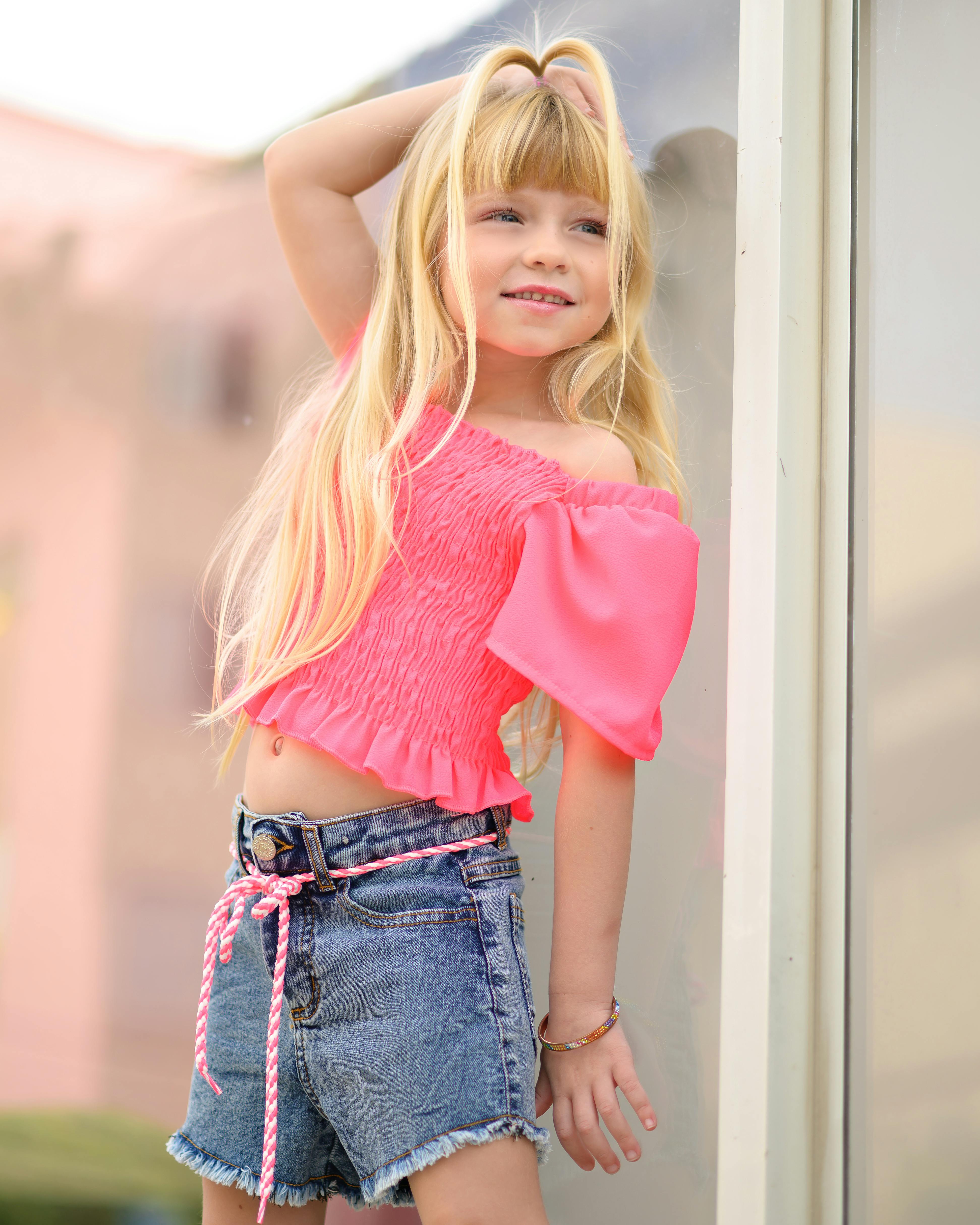 Blonde Girl Wearing Pink Blouse and Denim Shorts · Free Stock Photo