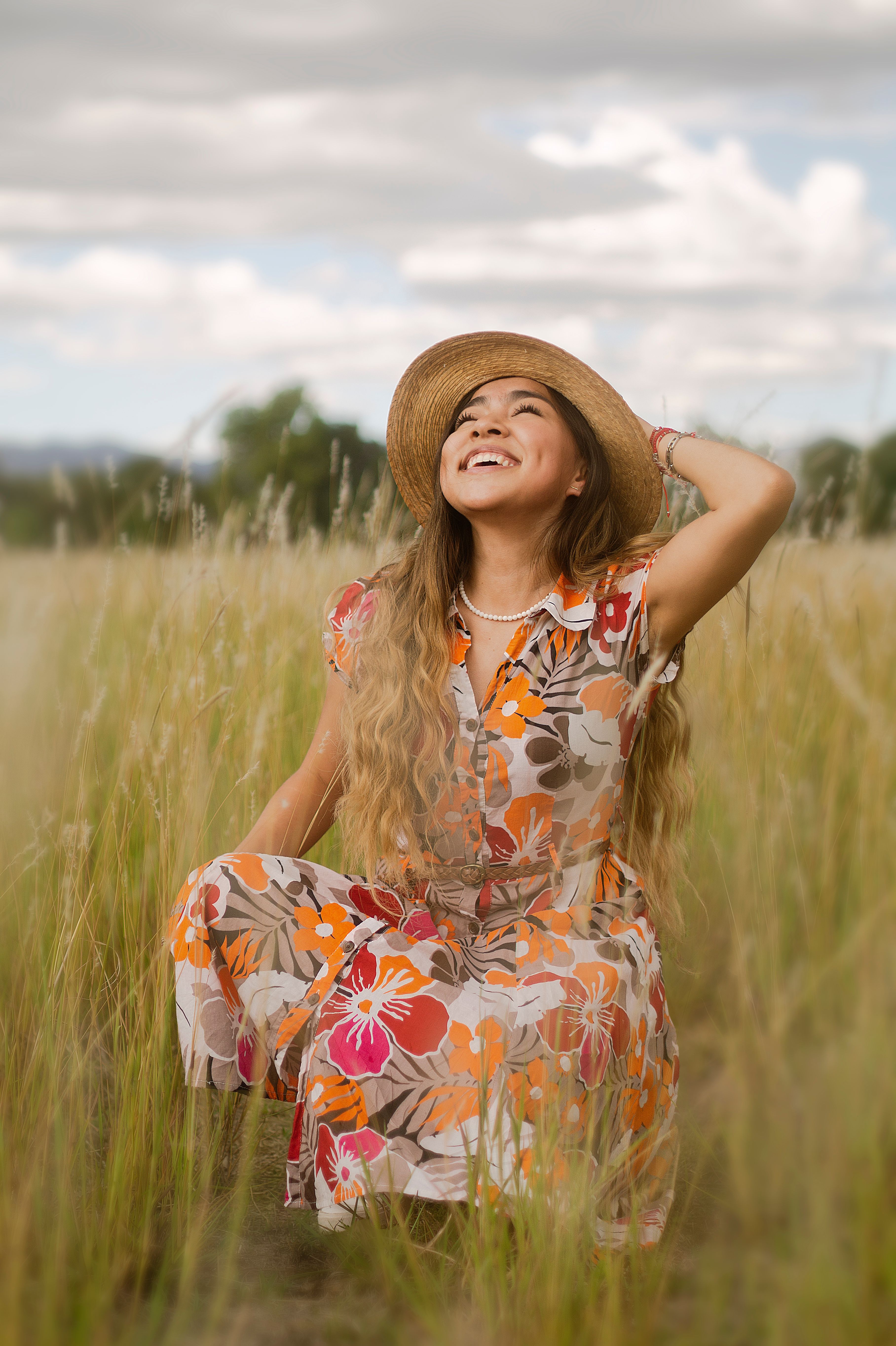 Woman in Floral Dress Standing on Grass Field · Free Stock Photo