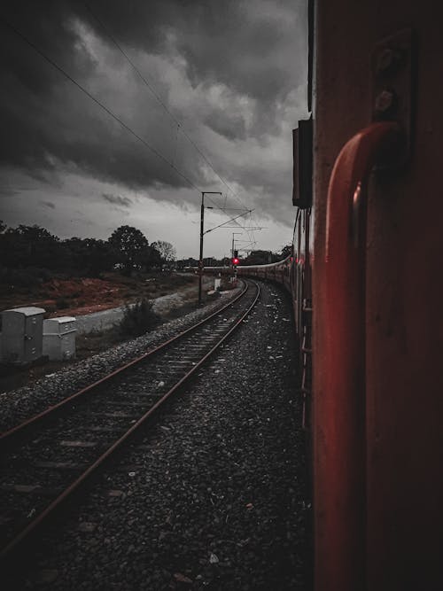 Train Travelling Under Cloudy Sky
