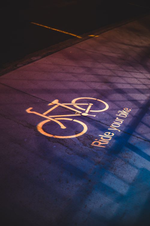 Free Abstract night image of a bicycle lane sign with shadows and dramatic lighting. Stock Photo