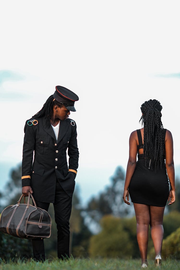 Man In A Pilot Uniform Looking At A Woman 