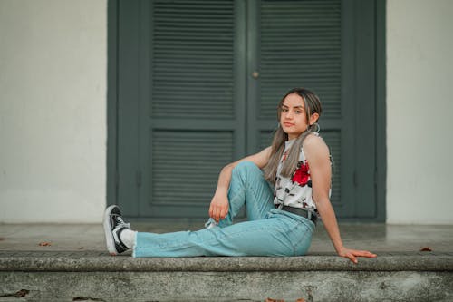 Woman in Floral Top Sitting on the Floor