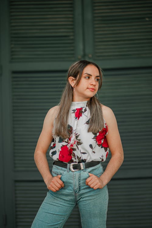 Free Woman in Red and White Floral Sleeveless Top and Blue Denim Shorts Stock Photo