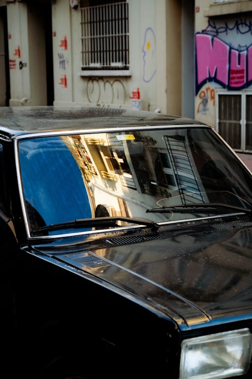 A Black Vintage Fiat Car parked on a Street