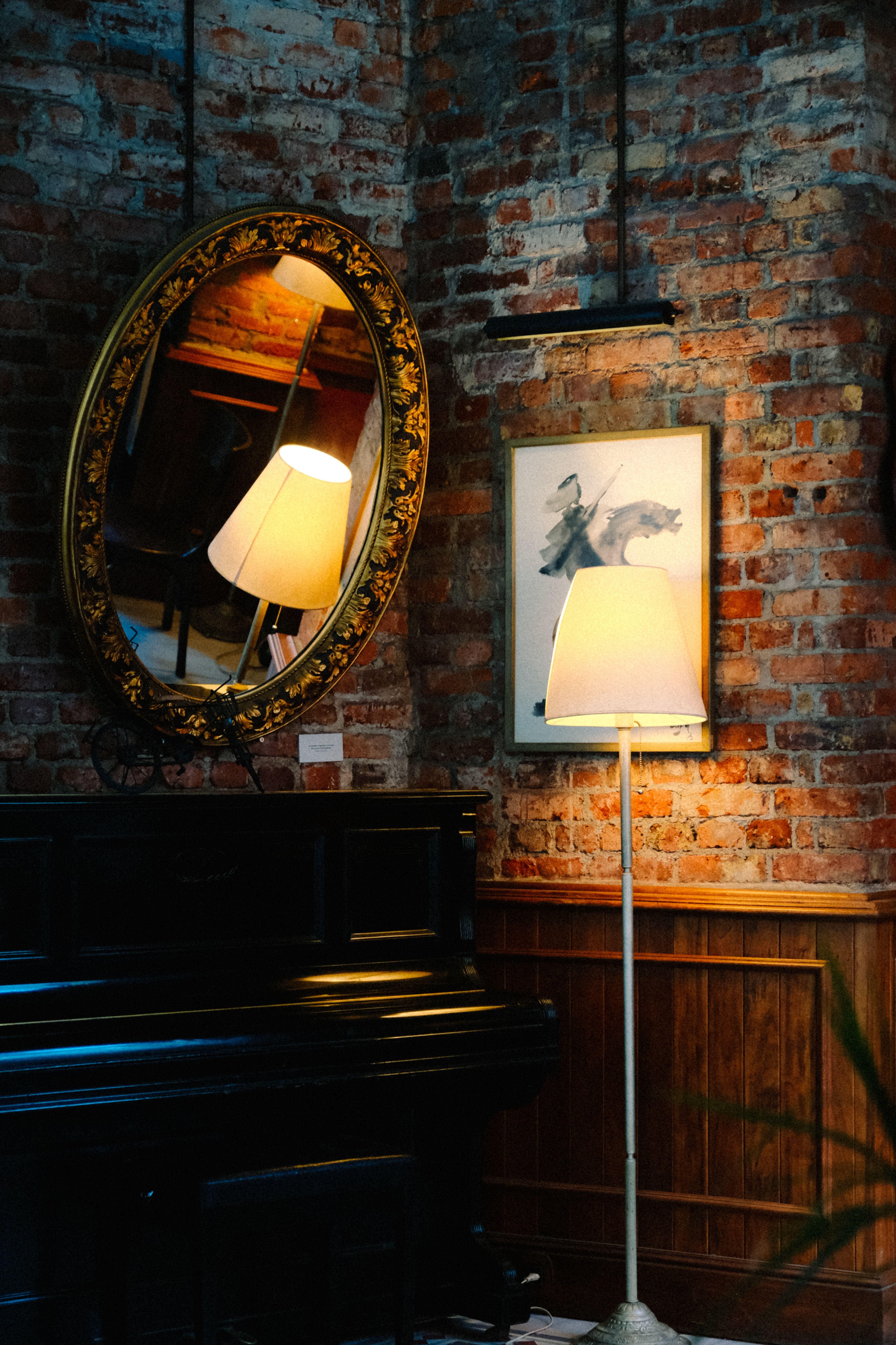 Brown Wooden Framed Wall Mirrors Near a Table Lamp · Free Stock Photo