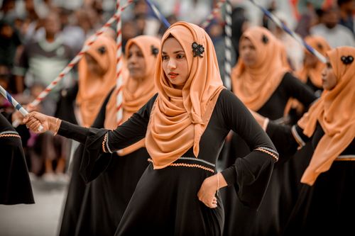 Free Young women in traditional attire performing cultural dance in Maldives festival. Stock Photo