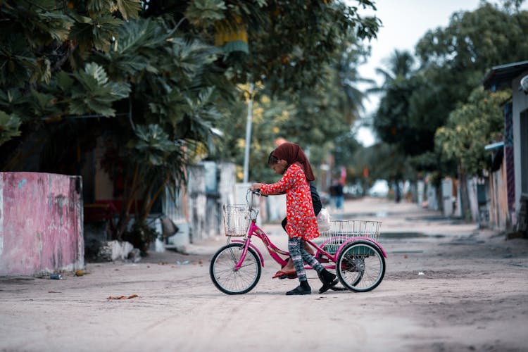 Kids Riding A Tricycle