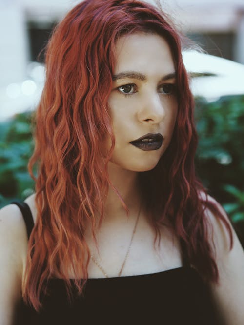 Portrait of Redhead Woman Wearing Black Lipstick