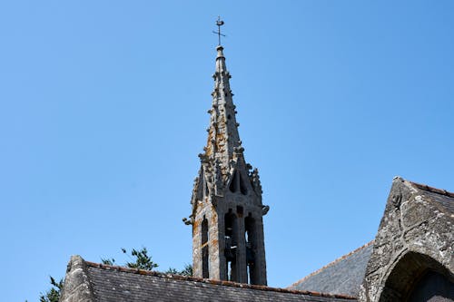 Moss-covered Stone Bell Tower of a Gothic Chapel in France