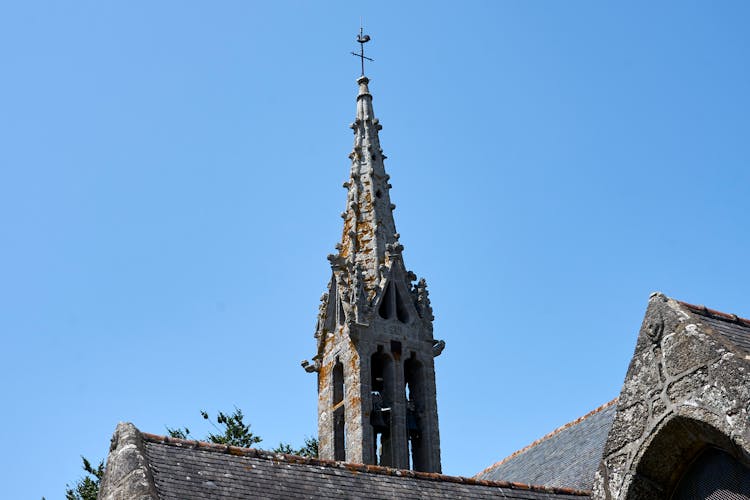 Moss-covered Stone Bell Tower Of A Gothic Chapel In France