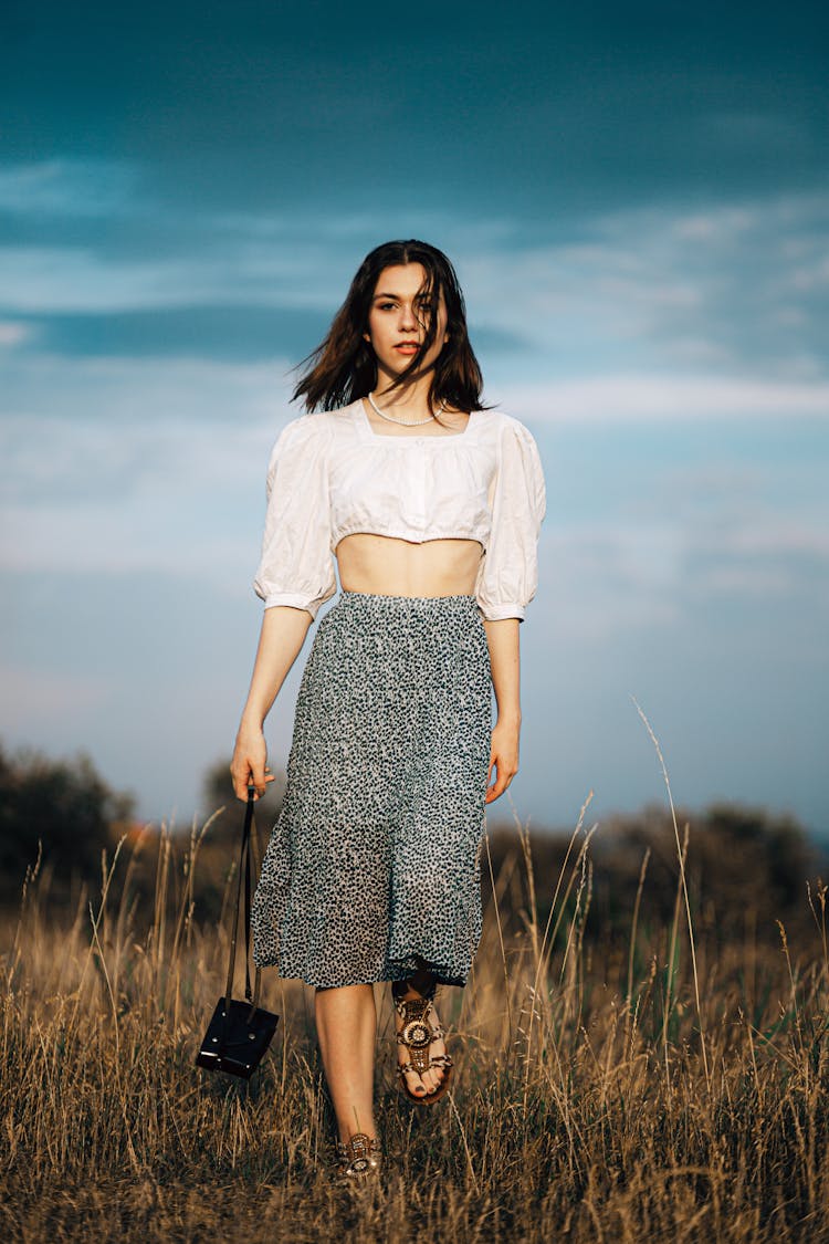 Brunette Walking In Long Skirt And Puff Blouse