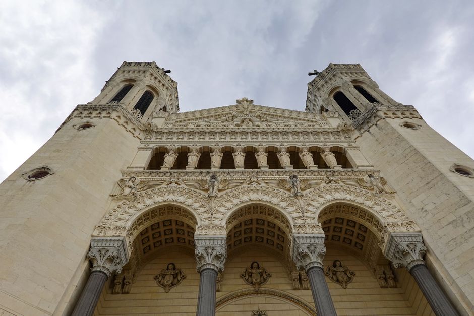 Low angle view of Lyon's Basilica facade showcasing intricate architectural details.