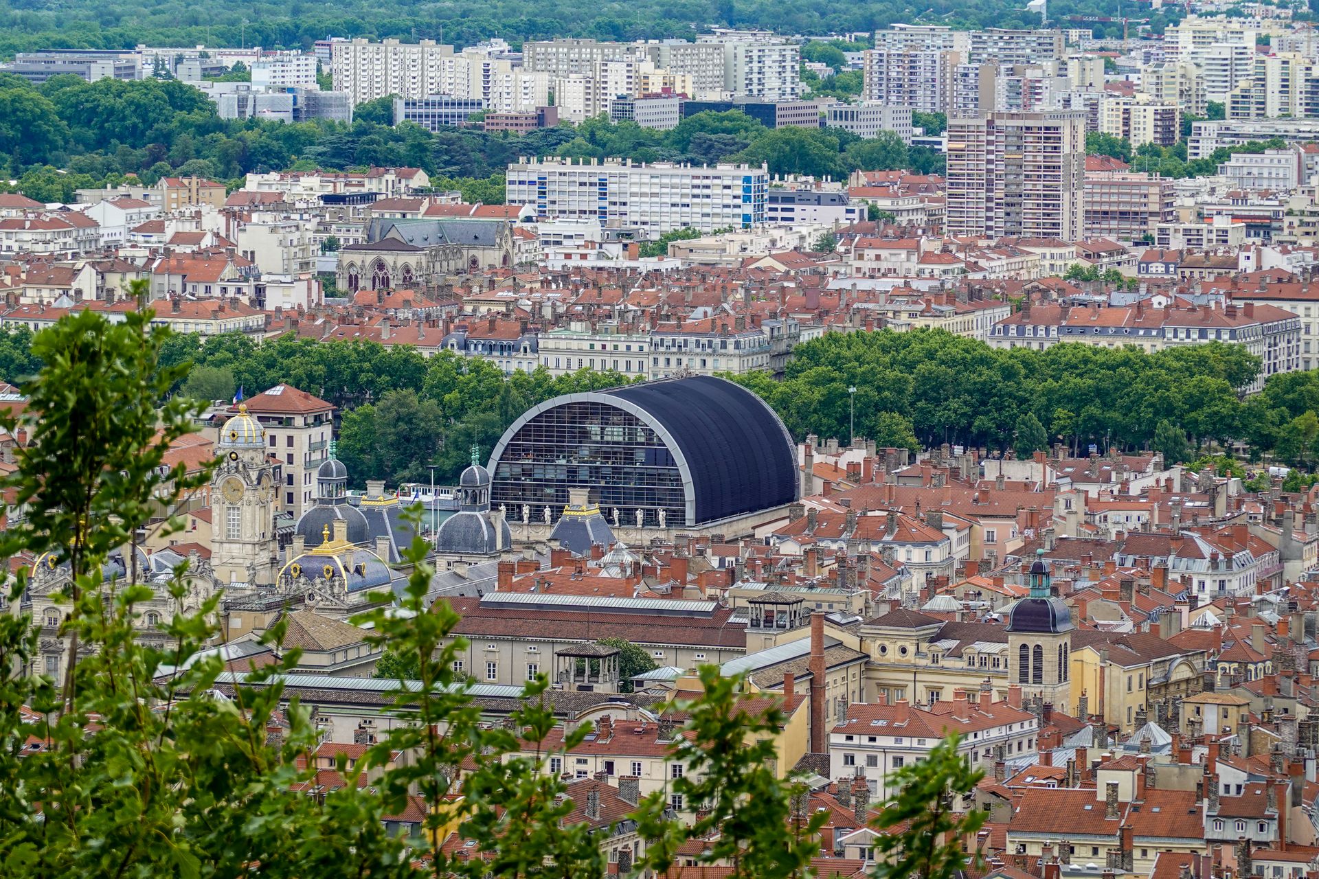 Aerial cityscape of Lyon featuring the Opera National de Lyon amidst urban architecture.