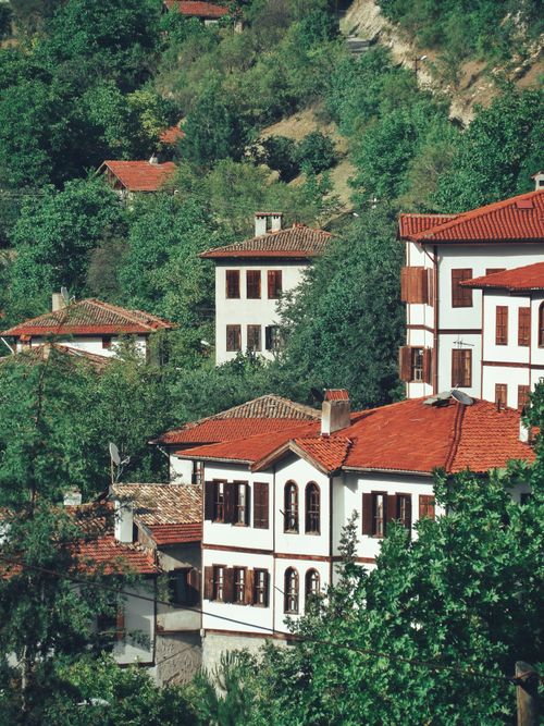 Free Scenic view of traditional village houses surrounded by lush greenery in a mountainous area. Stock Photo