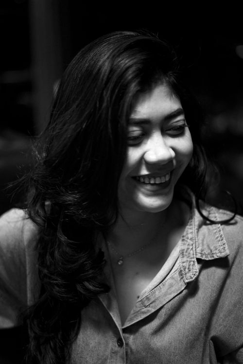 Free Elegant monochrome portrait of a woman with long hair smiling. Stock Photo