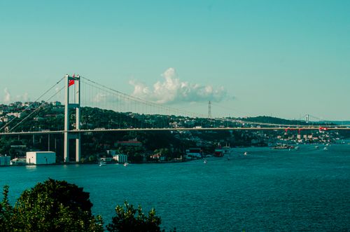 Free Bosphorus Bridge spans the water connecting Europe and Asia under a clear sky in Istanbul, Turkey. Stock Photo