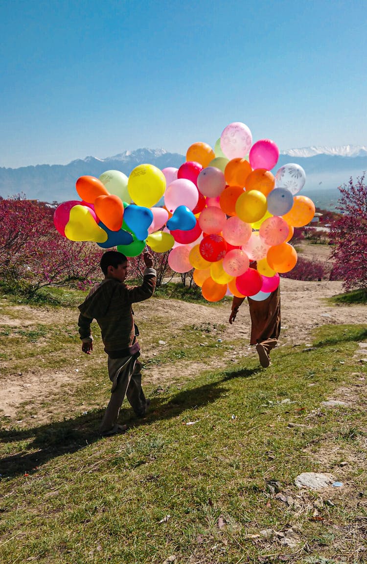 Boy Holding Balloons