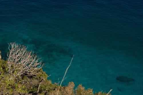 Free A breathtaking aerial view of the ocean with a nearby cliff, captured during the day. Stock Photo