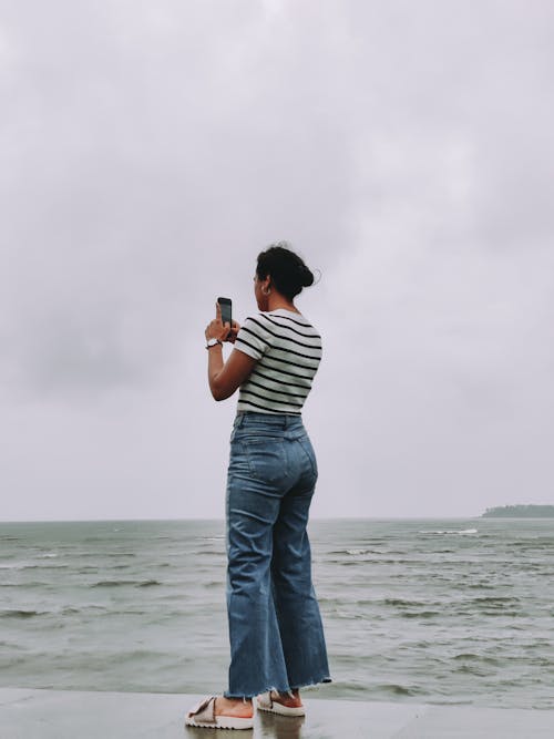 Kostnadsfri bild av denimjeans, kvinna, randig tröja