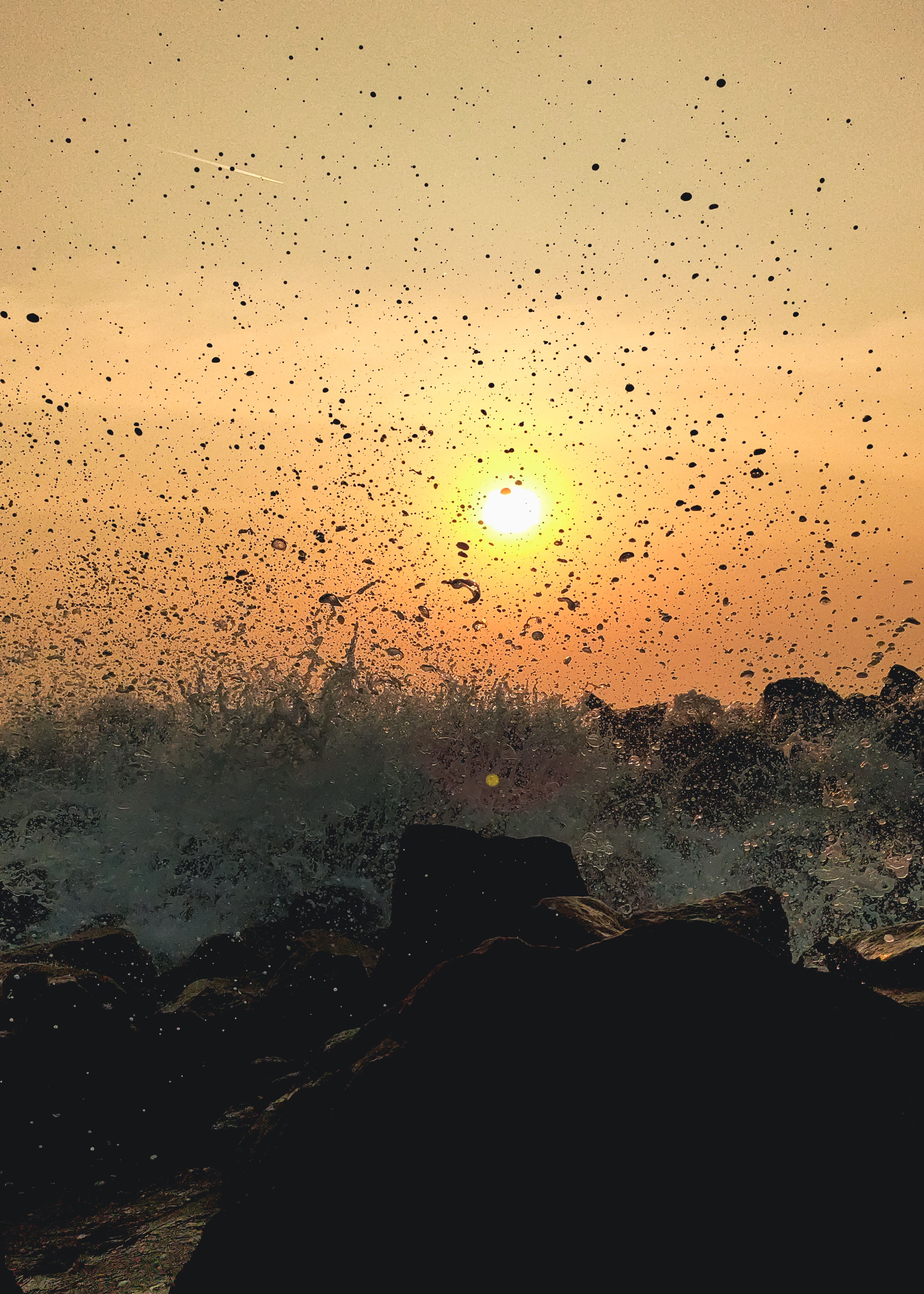 Waves Crashing on a Rocky Shore during the Golden Hour · Free Stock Photo