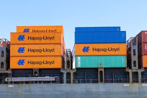 Free Colorful cargo containers stacked at an industrial port terminal. Stock Photo