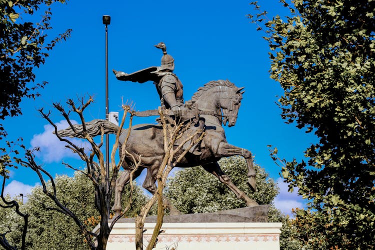 A Man Riding On Horse Statue Under The Blue Sky