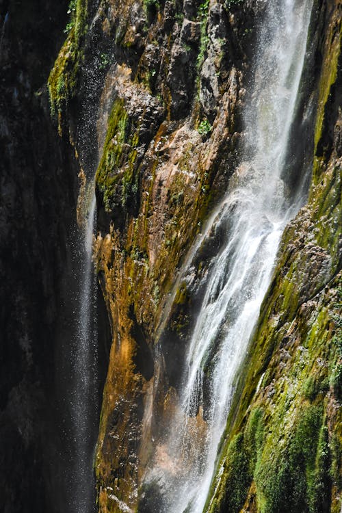 Free Waterfalls on Mossy Rock Mountain Stock Photo