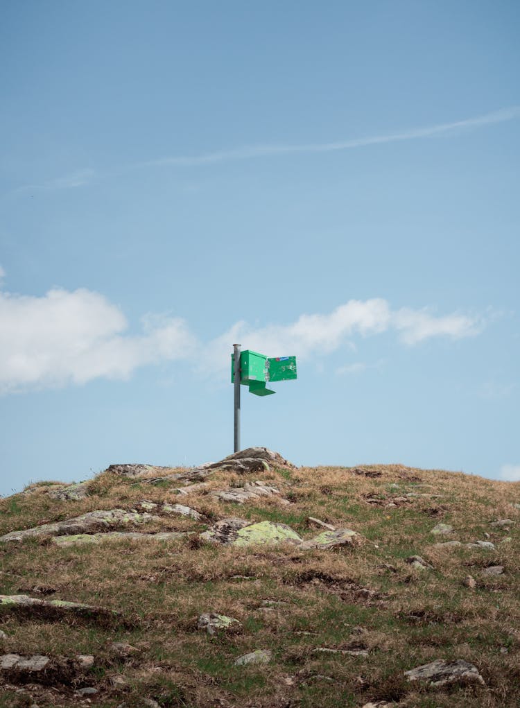 Green Box On A Hill Under Blue Sky