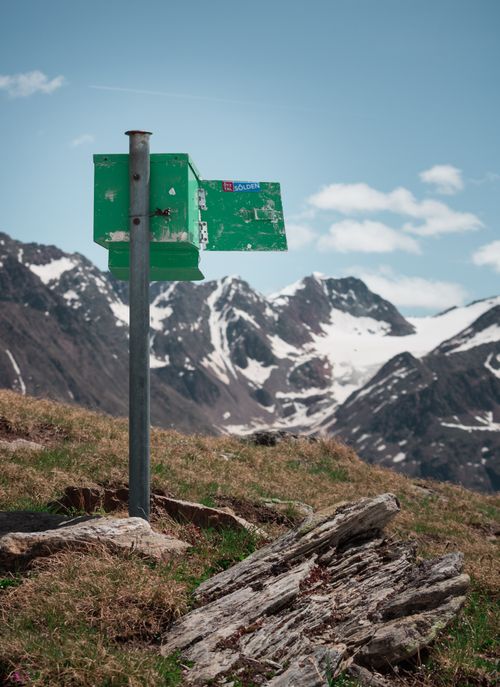 Free A scenic view of a weathered green mailbox amidst the Tirol mountains in summer. Stock Photo