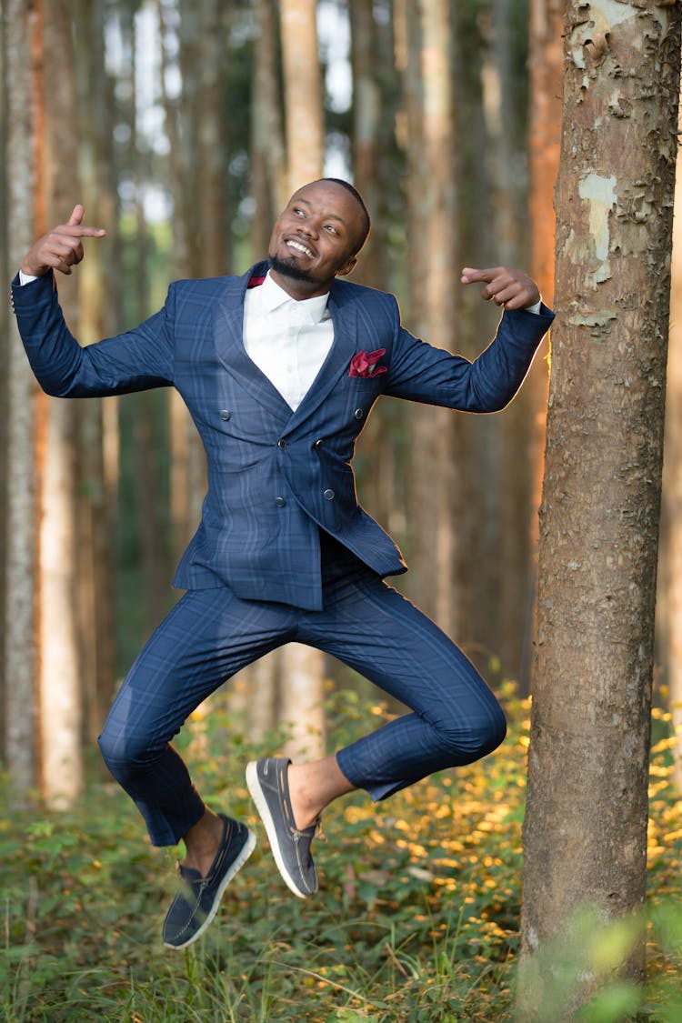 Jump Shot Of A Man In A Blue Suit