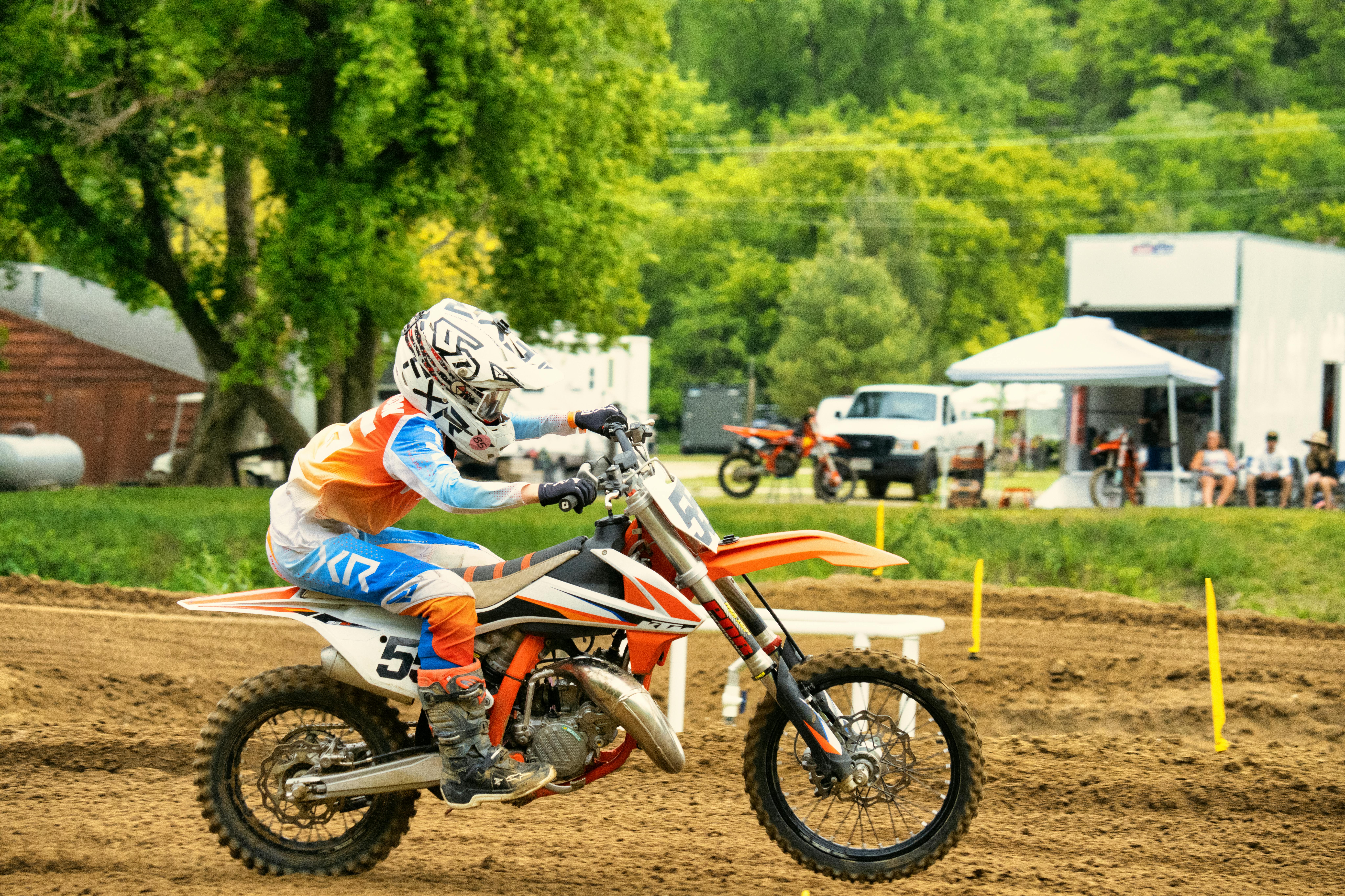 A young rider in colorful gear tackles a motocross trail in Millville, Minnesota.