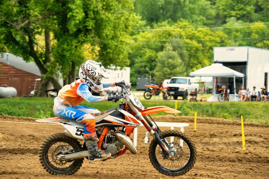 A Person in Full Safety Gear Riding on a Motocross Bike