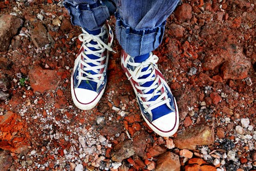 Person in Blue Denim Jeans in Blue and White Sneakers