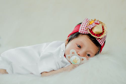Free Photograph of a Baby with a Pacifier Stock Photo