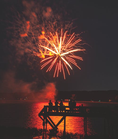 Free Fireworks Display over a Body Of Water Stock Photo