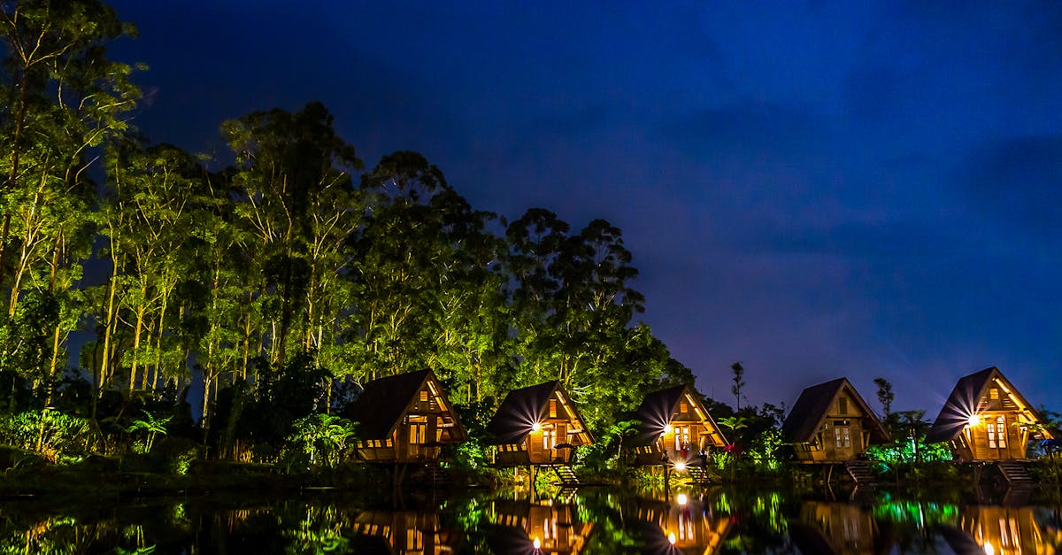 Brown Wooden House Near Body of Water during Night Time