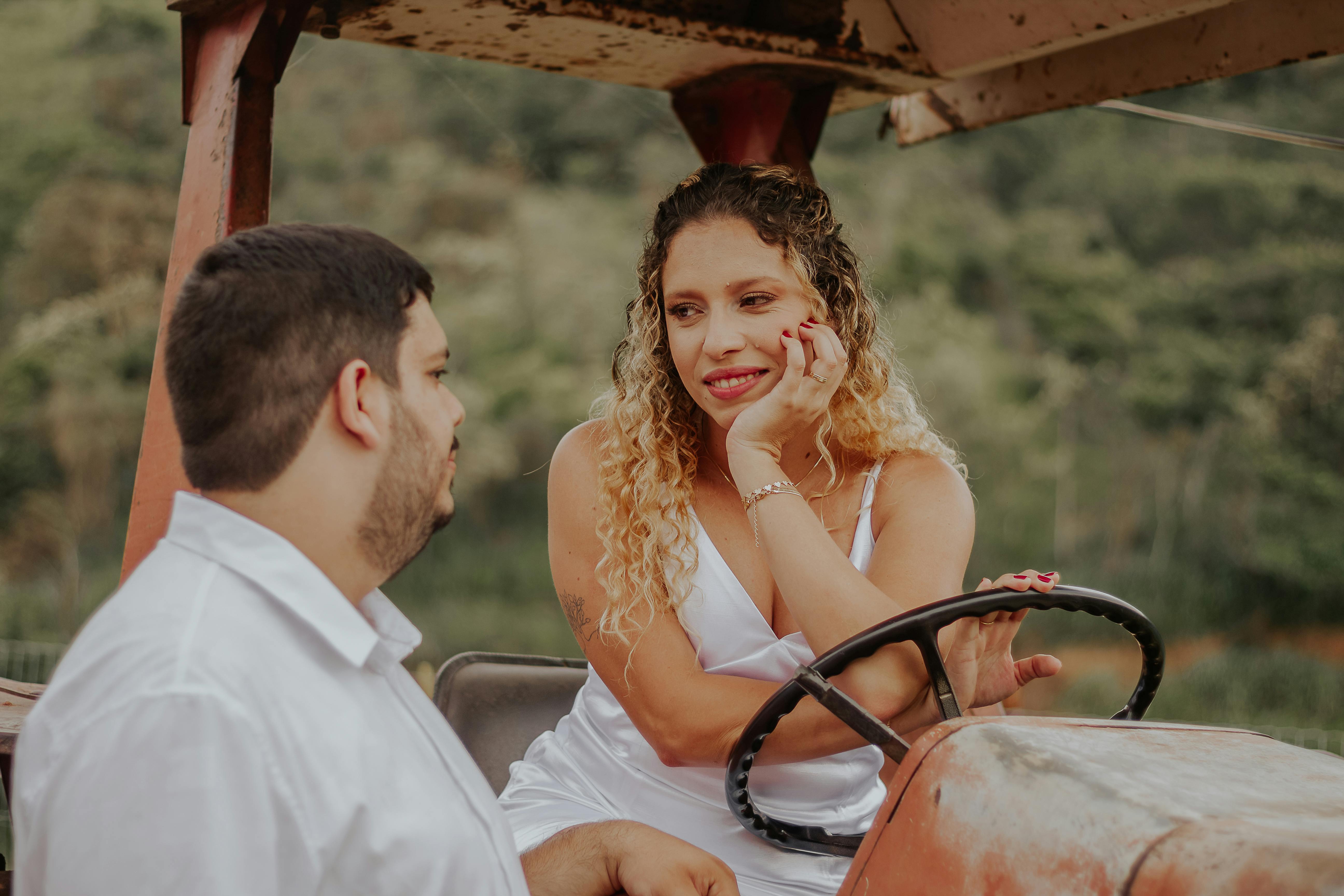 A loving couple sharing a moment on a vintage tractor in Brazil's countryside.