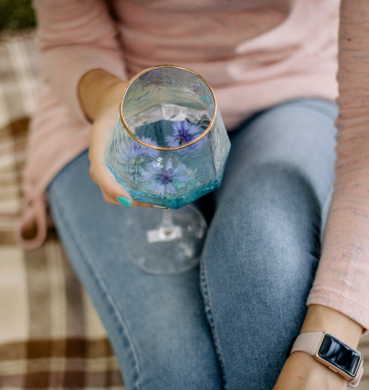 A Person Holding A Glass Of Water