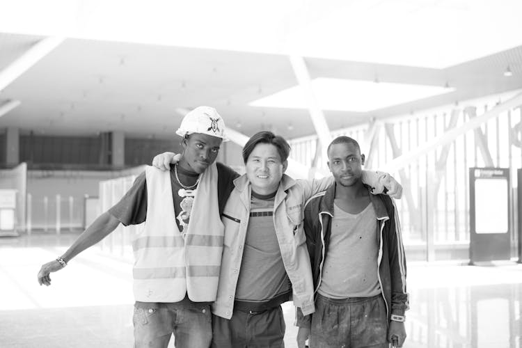 Black And White Photo Of A Smiling Men With Shoulder To Shoulder